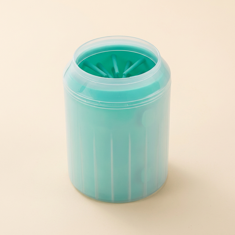 Green silicone dog paw cleaning cup on a cream background